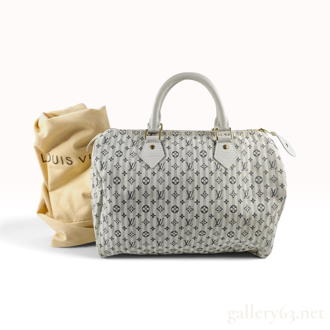 Vintage Louis Vuitton Monogram Mini Lin Croisette Speedy 30 Top Handle Bag with Dust Bag: This Louis Vuitton Speedy 30 top handle bag is crafted from Monogram Mini Lin Croisette canvas in the blanc colorway. The textile exterior features vertical navy blue stripes overlaid with a repeating