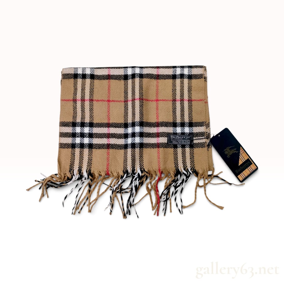 Vintage Burberrys Nova Check Tan Lambswool Scarf NWT: This vintage Burberrys scarf is crafted from 100 percent lambswool in the signature Nova Check pattern. The design consists of a tan ground decorated with a large-scale grid of black and white stripes