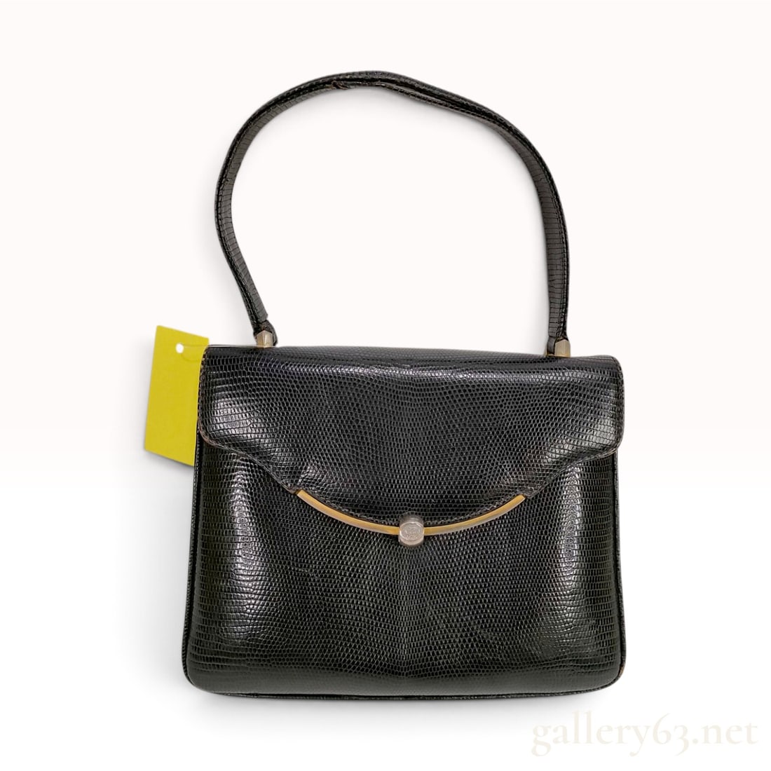 Vintage Celine Black Lizard Skin Top Handle Handbag: A vintage Celine structured handbag crafted from genuine black lizard skin. The bag features a classic rectangular silhouette with a curved front flap and a three-compartment gusseted interior. The