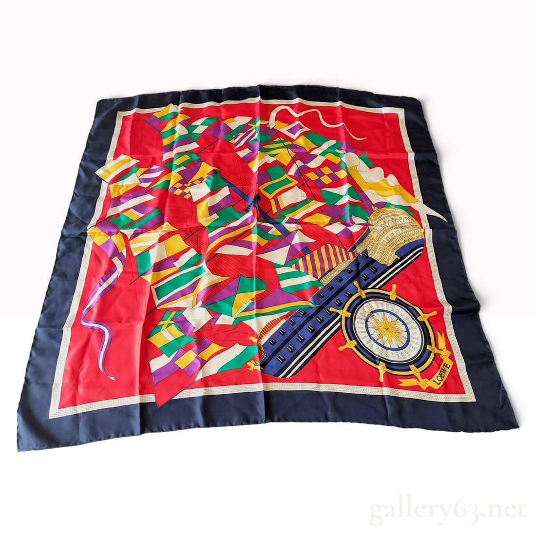 Vintage Loewe Nautical Signal Flag Motif Silk Scarf 90cm: This Loewe silk carre 90 is crafted from silk twill and features a vibrant nautical-themed motif. The central design displays an abstract arrangement of colorful signal flags in shades of purple, gree