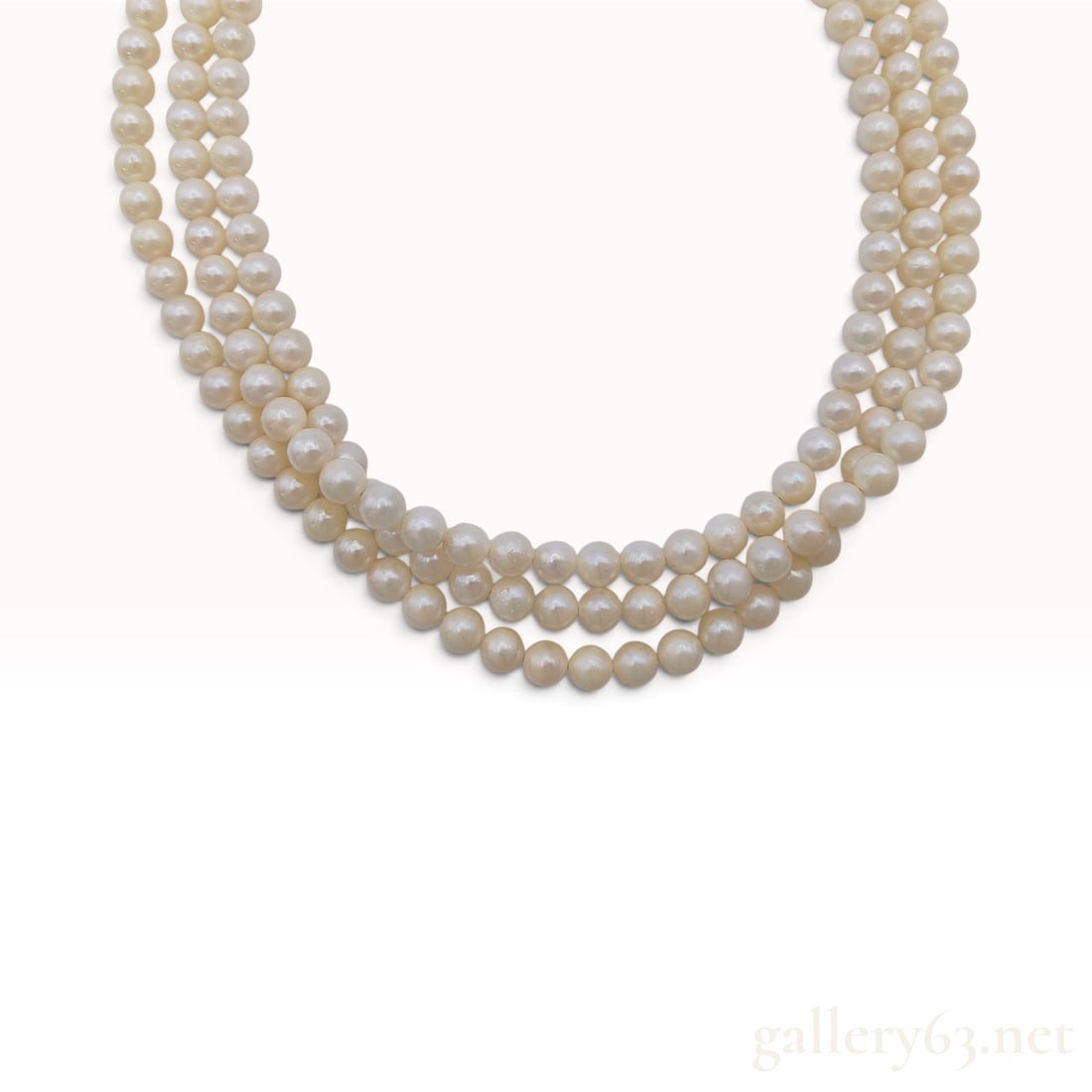 A Vintage Silver and Cream Cultured Pearl Triple Strand Necklace 16 Inch: This triple-strand necklace is crafted from three rows of individually knotted cream-colored cultured pearls. The pearls range from approximately 6mm to 7mm in diameter, exhibiting a creamy white colo
