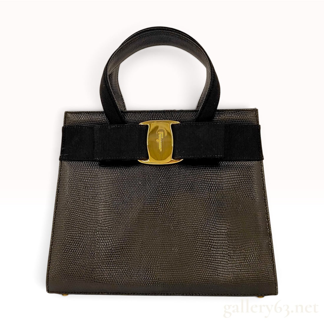Vintage Salvatore Ferragamo Vara Bow Black Lizard Embossed Leather Top Handle Bag: This vintage Salvatore Ferragamo top handle bag is crafted from structured black lizard-embossed leather. The front is accented with the signature Vara bow in black grosgrain ribbon, anchored by a gol