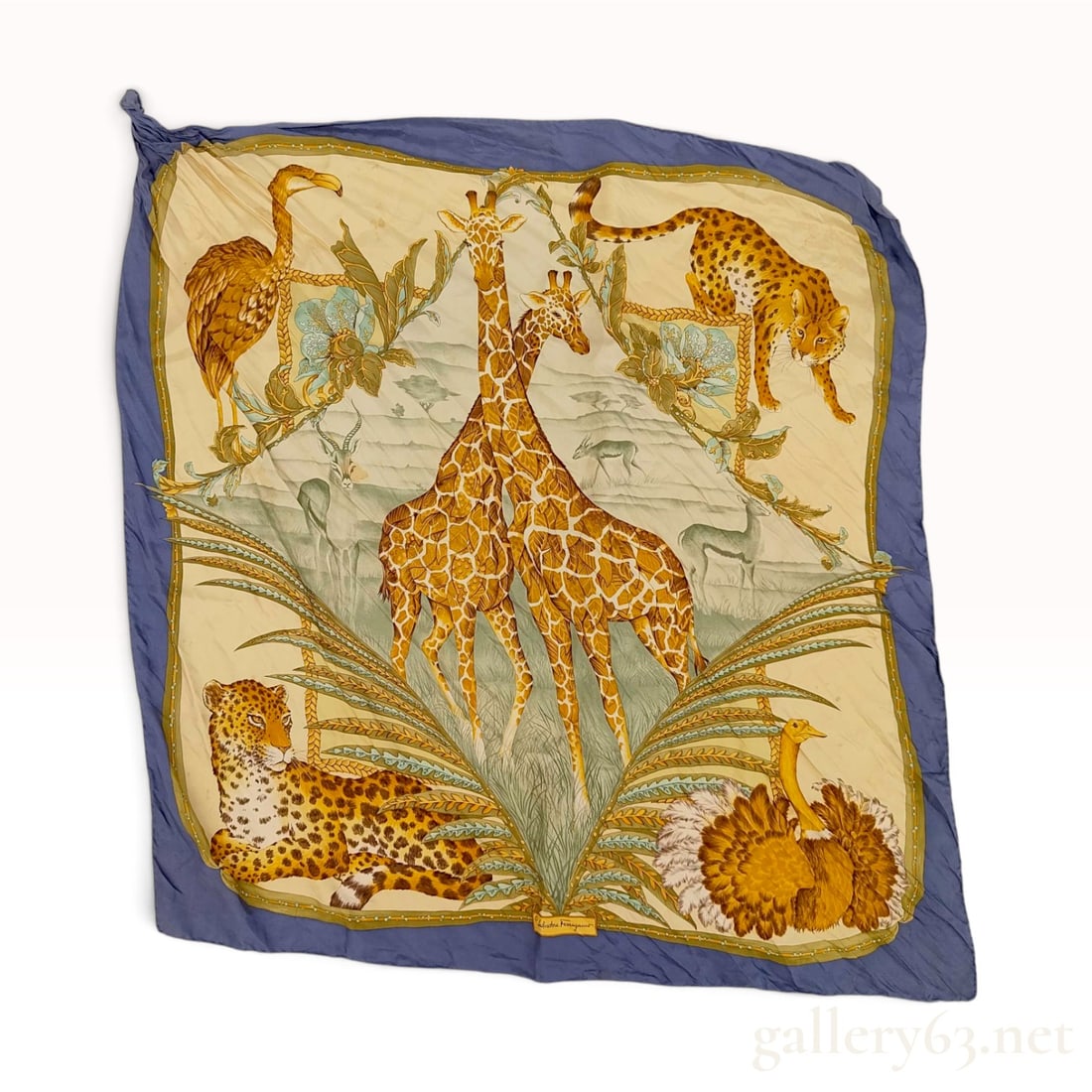 Salvatore Ferragamo Safari Animal Motif Navy Blue Silk Scarf 90 cm: This Salvatore Ferragamo silk scarf is crafted from 100% silk and features an elaborate safari animal motif. The central illustration depicts a pair of giraffes, a reclining leopard, an ostrich, a pou