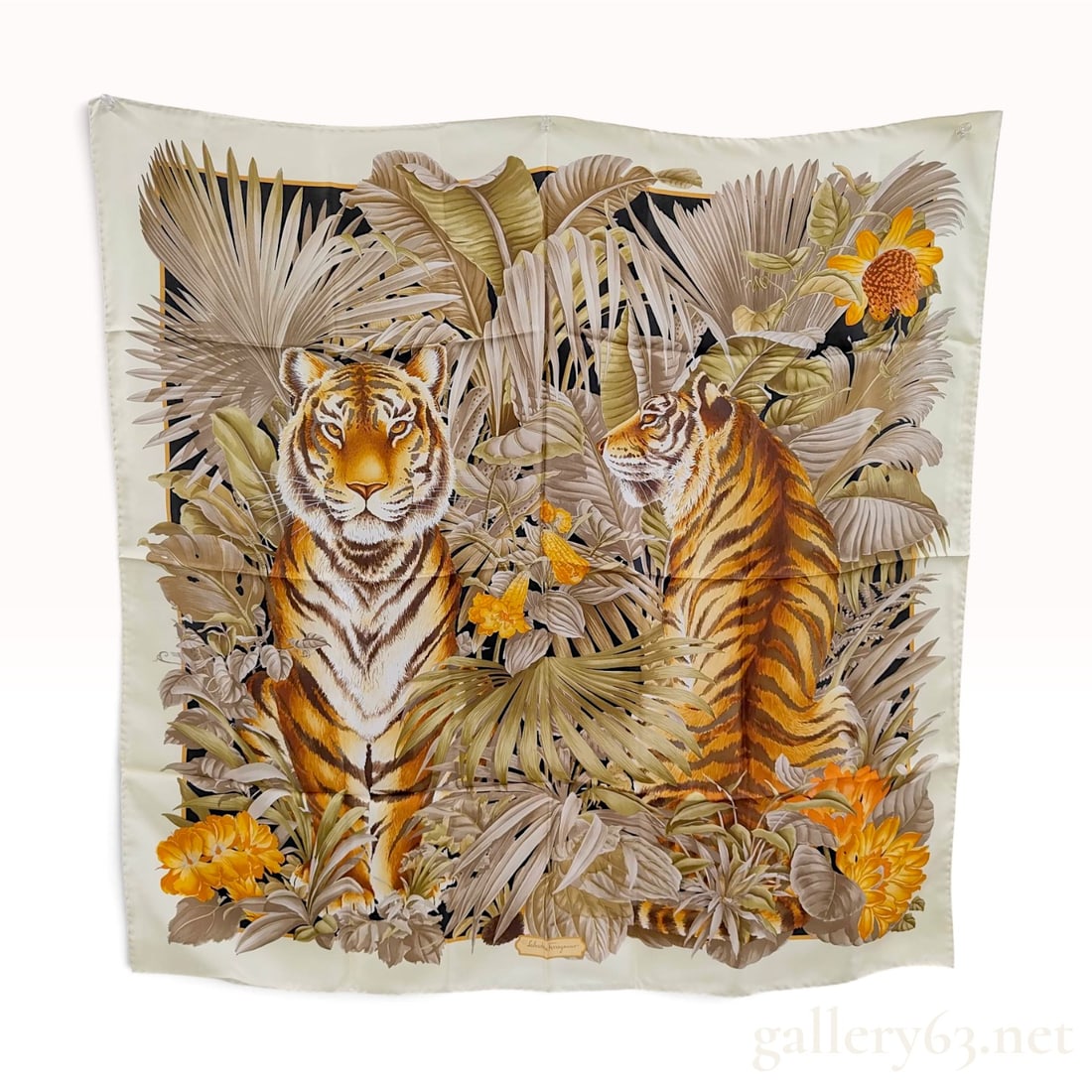 Salvatore Ferragamo Tiger and Tropical Foliage Neutral Silk Scarf 90 cm: This Salvatore Ferragamo scarf is crafted from silk twill and features a jungle-themed motif centered on two tigers amidst dense tropical greenery. One tiger is depicted facing forward, while the seco