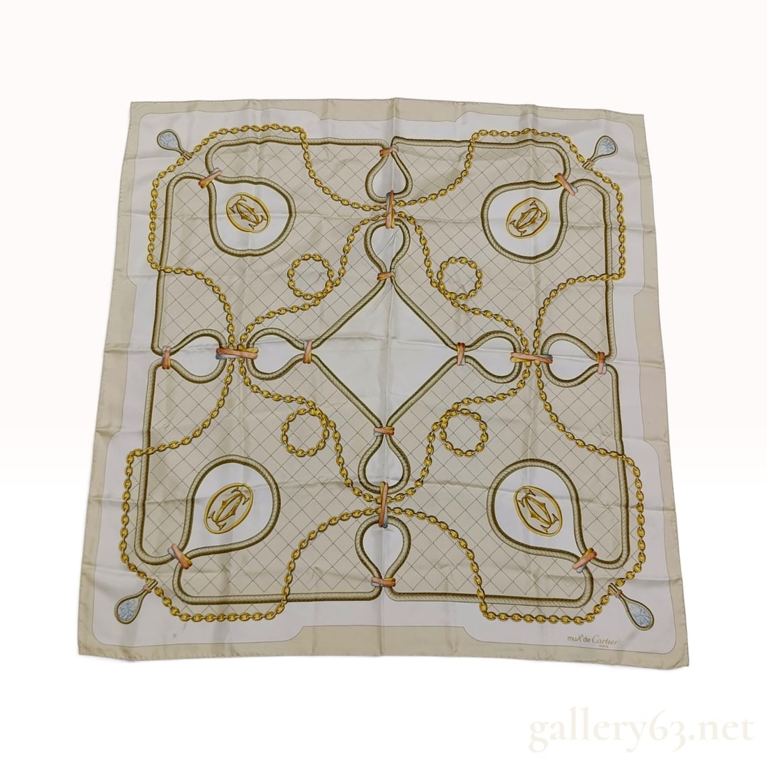 Vintage Must de Cartier Nautical Motif Cream Silk Scarf 90 cm: This Must de Cartier silk scarf is crafted from cream silk twill featuring a nautical jewelry-inspired design. The central field displays a diamond-lattice pattern overlaid with interlocking gold curb
