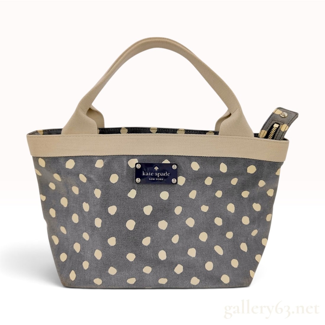 Kate Spade New York Grey Polka Dot Coated Canvas Small Tote Bag: This Kate Spade New York small tote bag is crafted from grey coated canvas featuring a cream polka dot motif. The bag is designed with beige woven textile double handles and a matching top trim. It is