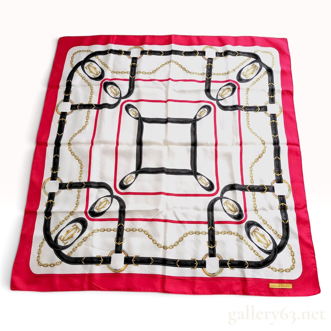 Vintage Cartier Belt and Chain Motif Red and Black Silk Carre 90: This Cartier silk carre 90 is crafted from silk twill and features an equestrian-inspired belt and chain motif. The design centers on an ivory white field decorated with interlacing black leather-styl