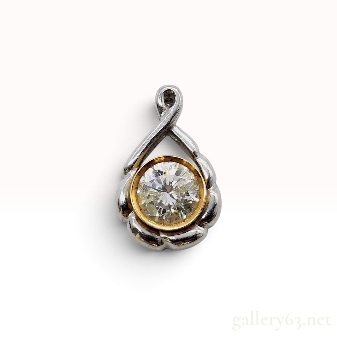 1.17ct Natural Diamond 18K Yellow Gold and Platinum Pendant: This pendant is crafted from platinum and 18 karat yellow gold centering a 1.17ct round brilliant-cut Natural Diamond. The central diamond is secured within an 18 karat yellow gold bezel setting that 
