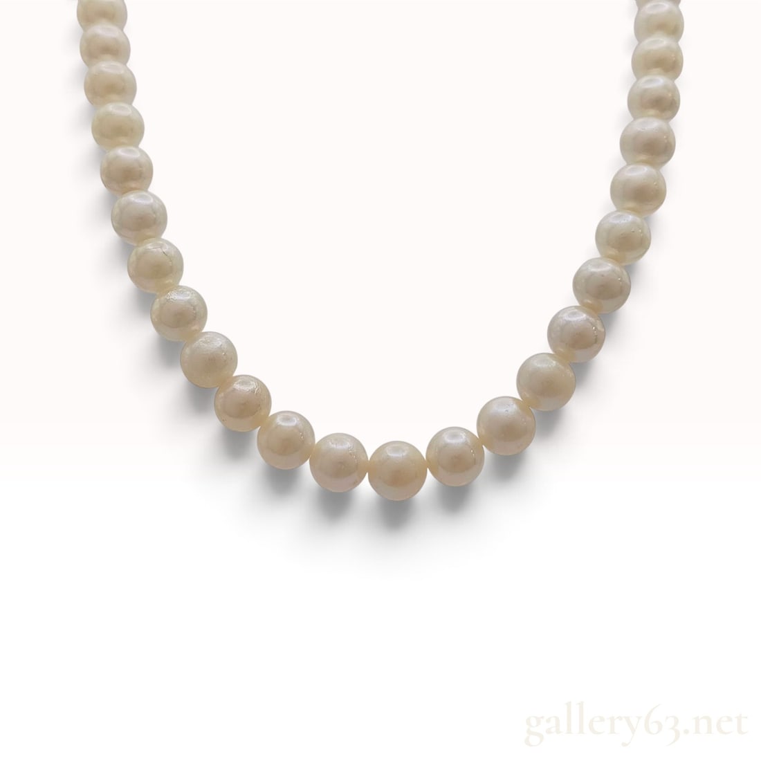 Vintage Silver and Graduated Cultured Pearl Necklace: This is a vintage graduated single-strand necklace composed of cream-colored cultured pearls. The strand features approximately 50 round to near-round pearls that graduate in size toward the center, d
