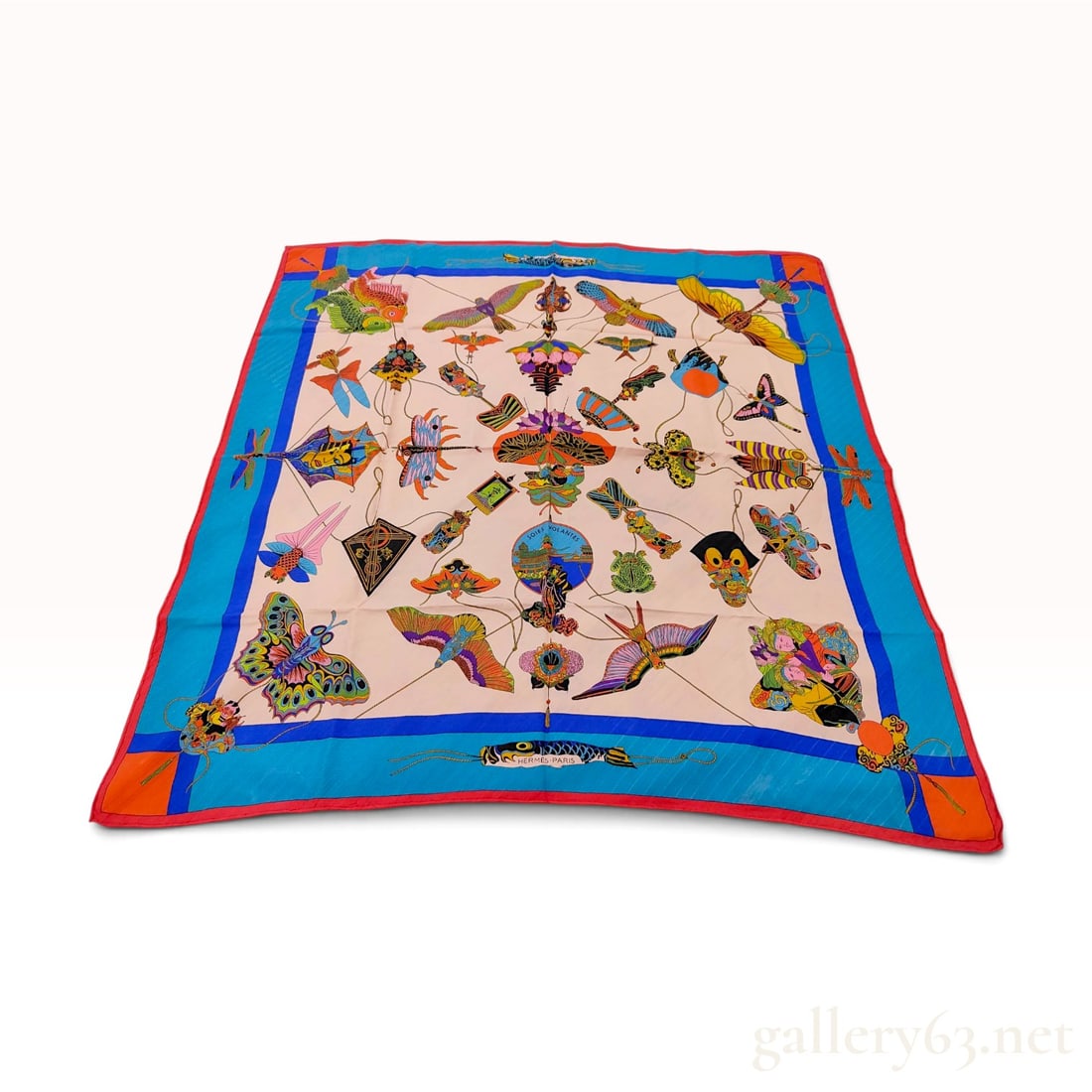 Hermes Soies Volantes (Flying Silks) Silk Carre 90: This Hermes silk carre 90 in the Soies Volantes pattern was designed by Loic Dubigeon and originally issued in 1992. The design features an array of colorful and intricate kites in various forms inclu