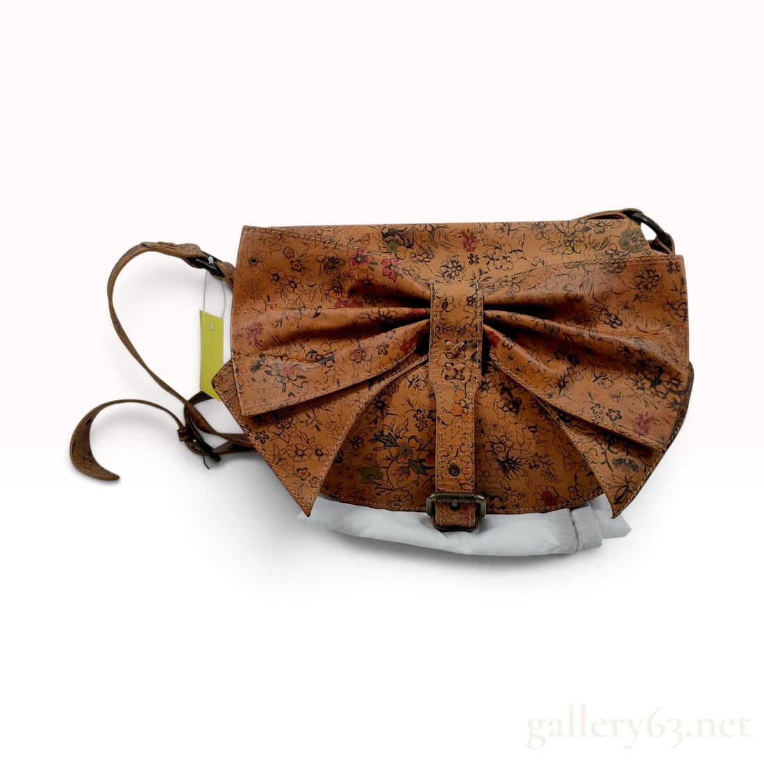 RED Valentino Floral Printed Leather Large Bow Crossbody Bag with Dust Bag: This RED Valentino crossbody bag is crafted from tan leather featuring an all-over floral print in shades of red, orange, and green with black outlines. The front flap is defined by a prominent, overs