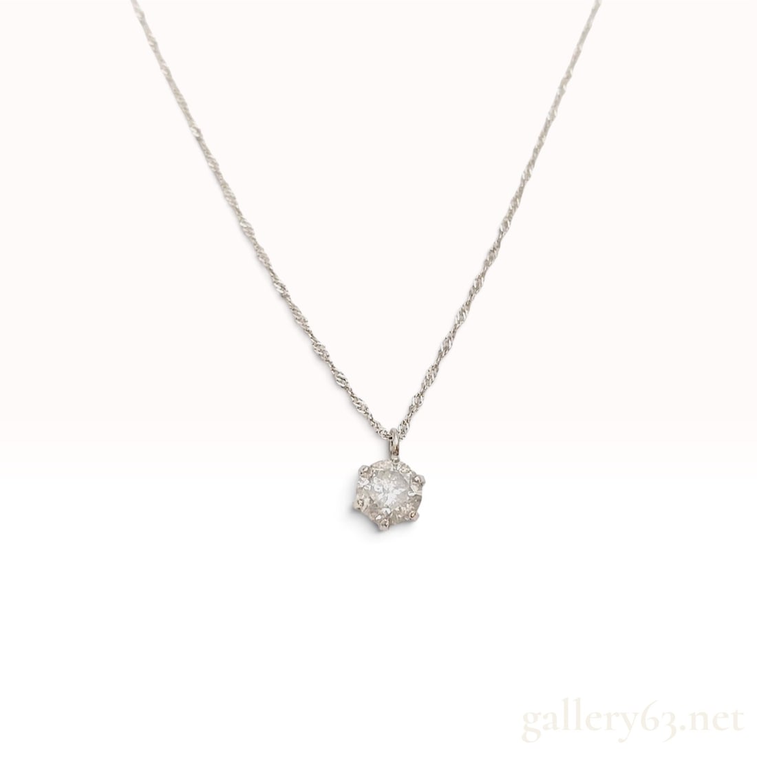 Platinum and 0.40ct Natural Diamond Solitaire Pendant Necklace: This platinum pendant necklace is crafted with a single round brilliant-cut natural diamond. The gemstone is held in a six-prong basket setting and suspended from a Singapore-style twisted link chain.