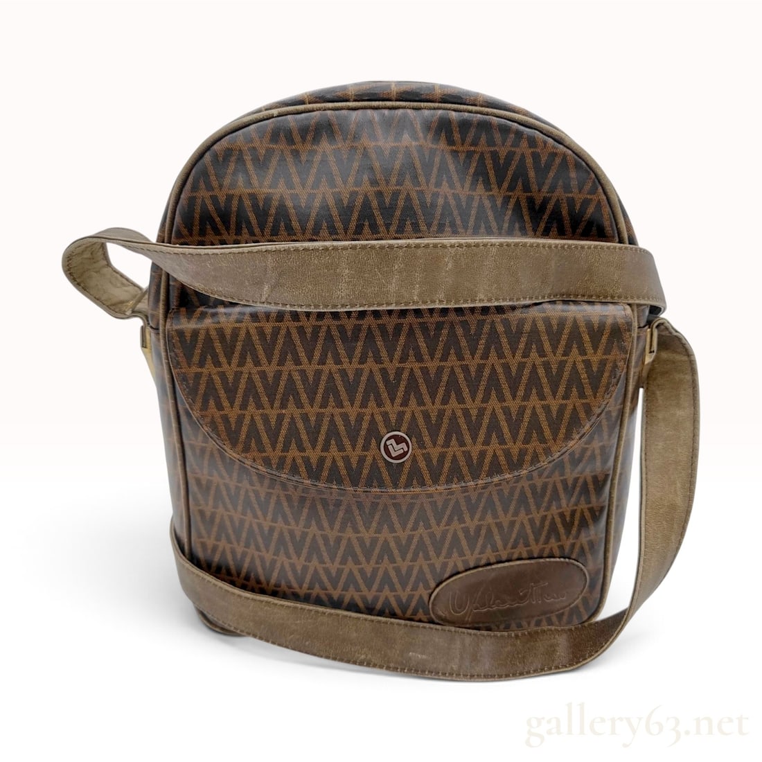 Vintage Mario Valentino Monogram Brown Coated Canvas Crossbody Bag: A vintage Mario Valentino crossbody bag crafted from brown monogrammed coated canvas with taupe leather trim and an adjustable flat shoulder strap. The exterior features an all-over repeating V monogr
