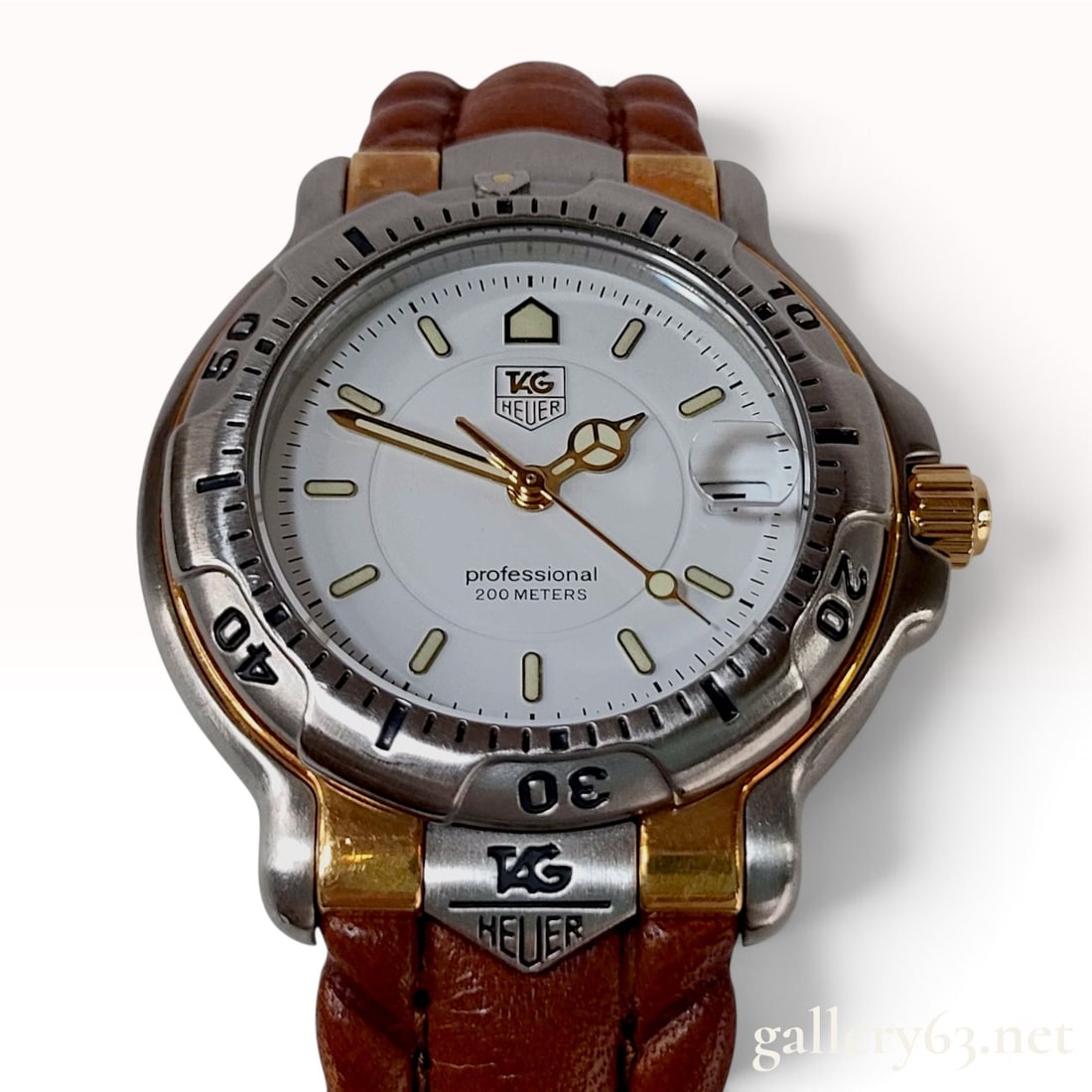 Vintage TAG Heuer 18K Gold and Stainless Steel 6000 Series WH1251-K0 Professional Wristwatch 36mm: This TAG Heuer 6000 Series professional wristwatch is crafted from stainless steel with 18 karat gold accents. The timepiece features a white dial with luminous dot and baton hour markers, gold-trimme