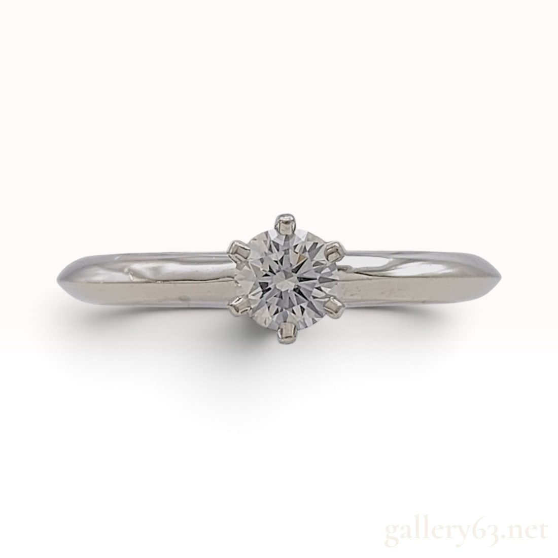 Tiffany and Co H-VS1-EX-FAINT Platinum and 0.25ct Natural Diamond Ring: This Tiffany and Co solitaire ring is crafted from high-polish platinum. The classic design features a 0.25ct round brilliant-cut natural diamond secured within a traditional six-prong crown setting. 