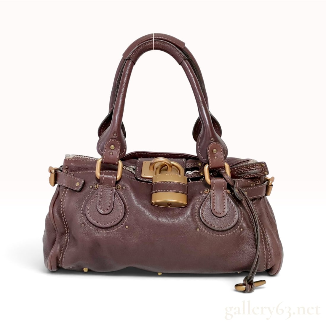 Vintage Chloe Paddington Dark Brown Grained Leather Satchel Bag: This Chloe Paddington satchel is crafted from supple, grained dark brown leather. The slouchy silhouette features dual rolled leather top handles secured by decorative antiqued brass-tone buckles and 
