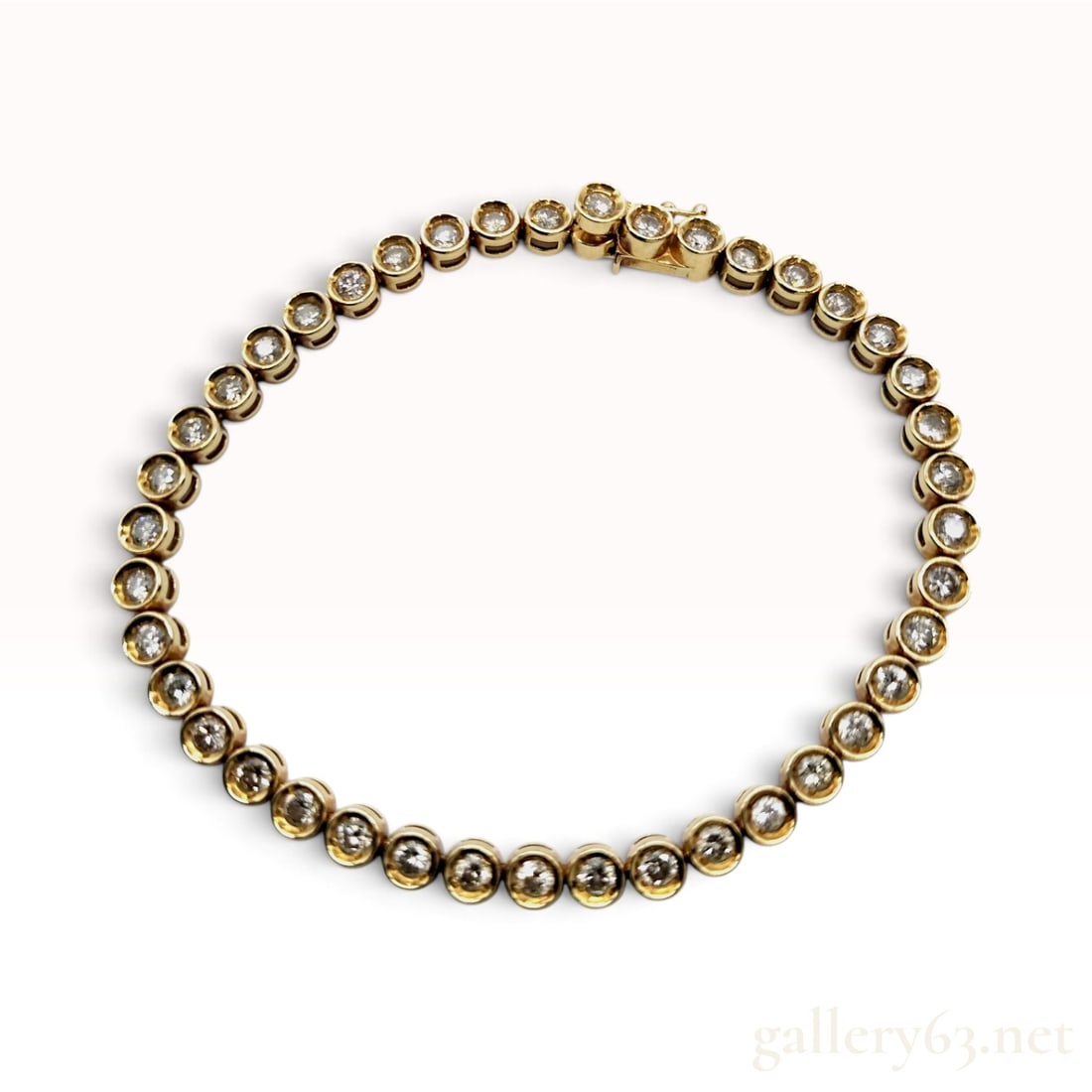 3.00ctw Natural Diamond 18K Yellow Gold Tennis Bracelet: This 18 karat yellow gold tennis bracelet features a continuous line of approximately 50 round brilliant-cut natural diamonds. Each diamond is secured within a circular bezel setting designed with ope