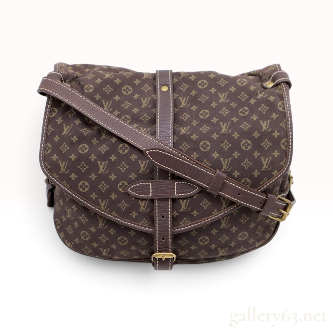 Vintage Louis Vuitton Monogram Mini Lin Saumur 30 Ebene Crossbody Bag: This Louis Vuitton Saumur 30 crossbody bag is crafted from ebene brown Monogram Mini Lin textile canvas with dark brown textured leather trim and cream contrast stitching. The design features a double