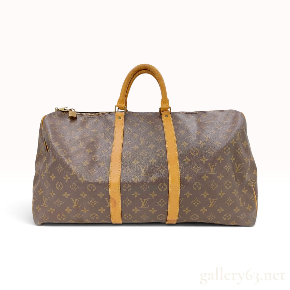 Vintage Louis Vuitton Monogram Keepall 60 Duffle Bag with Padlock: This Louis Vuitton Keepall 60 duffle bag is crafted from signature brown Monogram coated canvas. The bag features natural vachetta leather trim, including two long vertical straps, base piping, and do