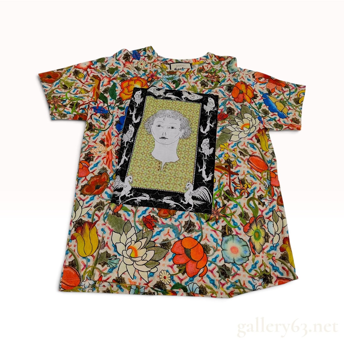 Gucci Garden Flora Print Multicolored Cotton T-Shirt Large: This Italian-made Gucci T-shirt is crafted from 100% cotton and features an all-over multicolored floral print. The front features a central rectangular panel with a black border depicting a stylized 