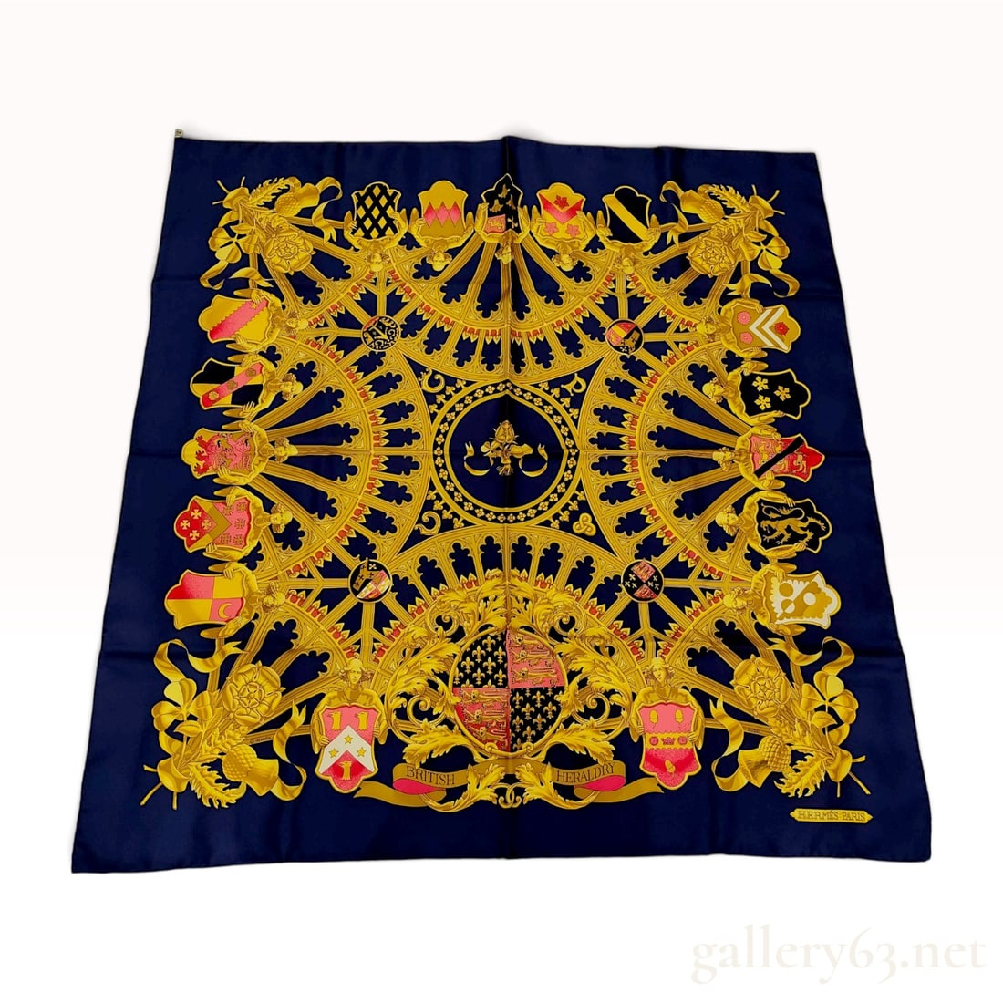 Vintage Hermes British Heraldry Blue Silk Carre 90: This Hermes silk carre 90, designed by Vladimir Rybaltchenko under the signature Rybal, is titled British Heraldry and features a complex arrangement of coats of arms and heraldic crests. The design i