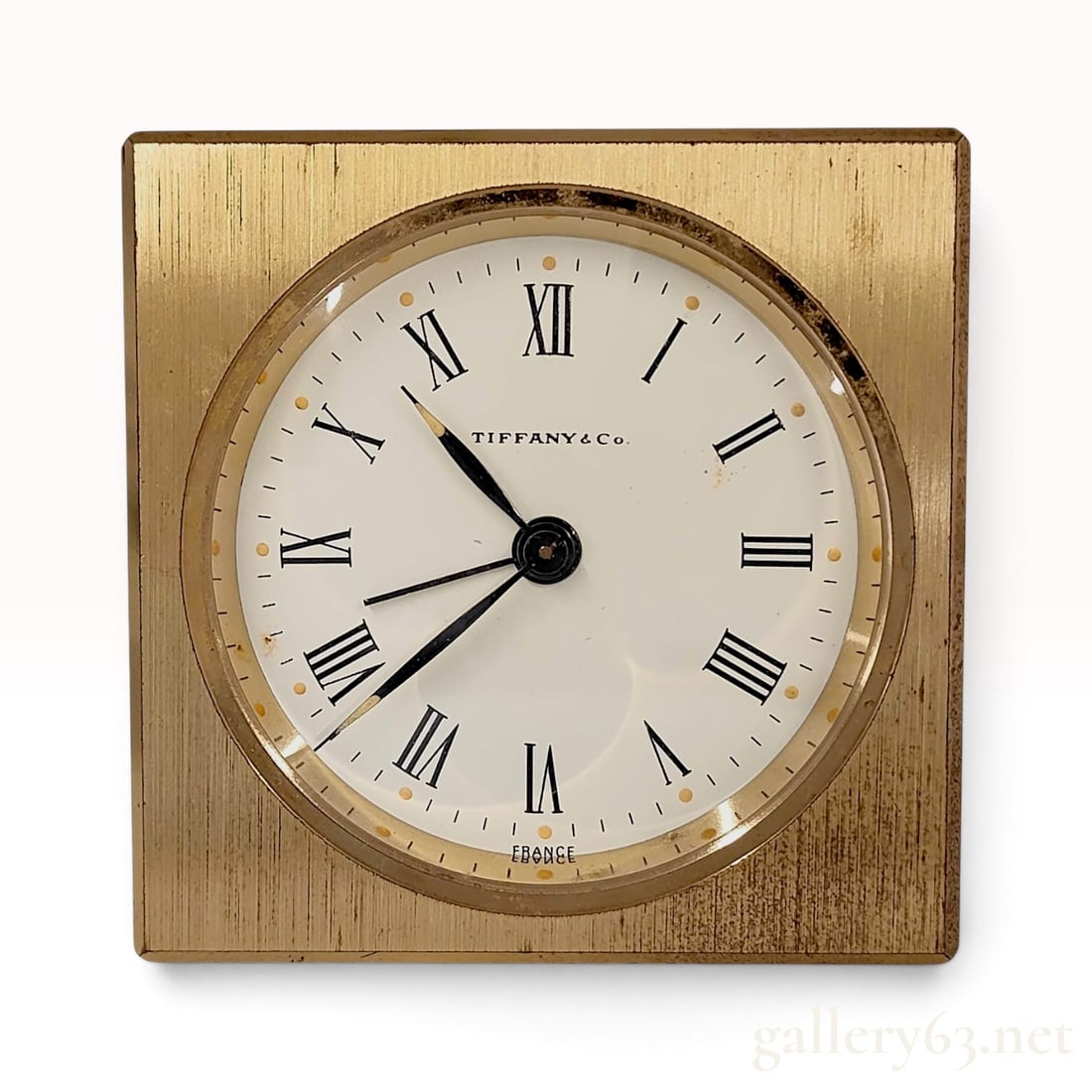 Vintage Tiffany & Co Brushed Brass 8-Day Alarm Desk Clock: This is a Tiffany & Co. desk alarm clock crafted from brushed brass. The white square dial is set with black Roman numeral hour markers, an outer minute track, and luminous dots at each hour. It has t