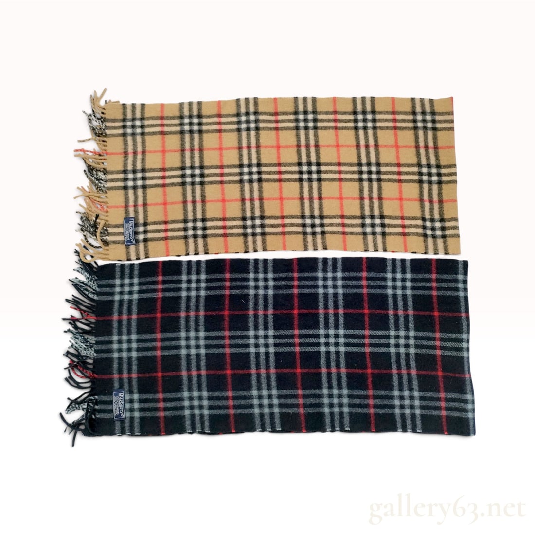 Two Vintage Burberrys Nova Check and Black Check 100% Cashmere Scarves: A pair of vintage Burberrys scarves crafted from 100% cashmere. The collection includes one scarf featuring the signature camel Nova check pattern with black, white, and red stripes, and a second scar