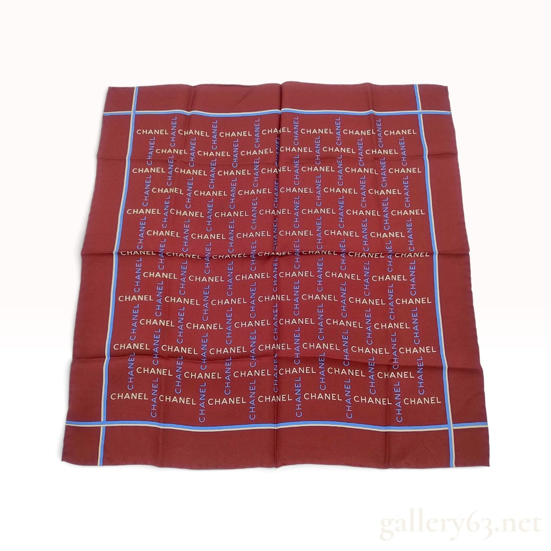Vintage Chanel Logo Pattern Burgundy Silk Scarf 45 cm: This Italian-made Chanel silk scarf is crafted from 100% silk featuring the repeating Chanel name throughout the design. The dark burgundy red ground is printed with a vertical and horizontal grid of 