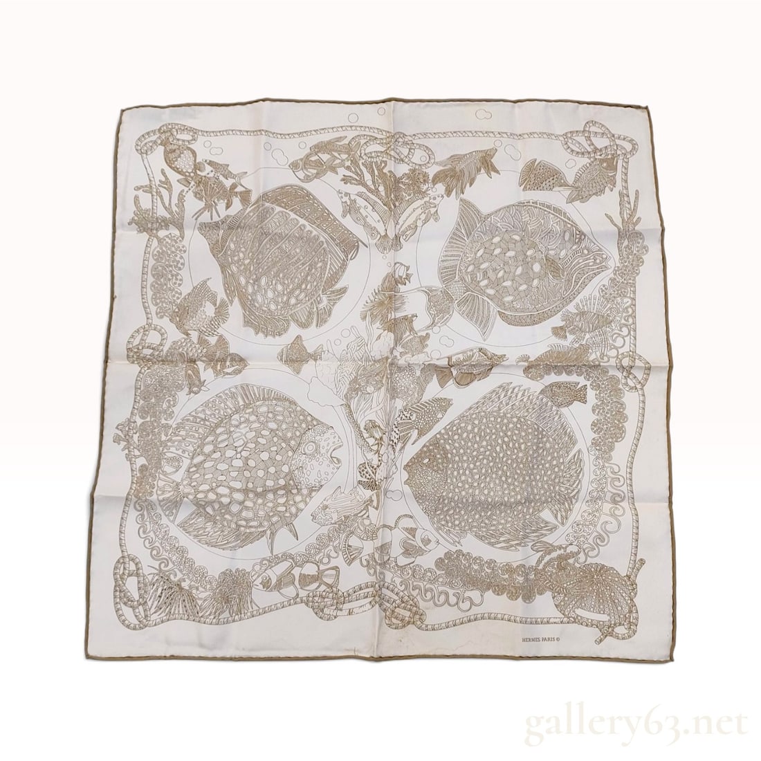 Vintage Hermes Les Poissons Brown and Cream Silk Carre 45: A French-made Hermes silk carre 45 crafted from silk twill in the Les Poissons (The Fish) pattern designed by Hugo Grygkar. The monochromatic illustration features various tropical fish, coral, and sh