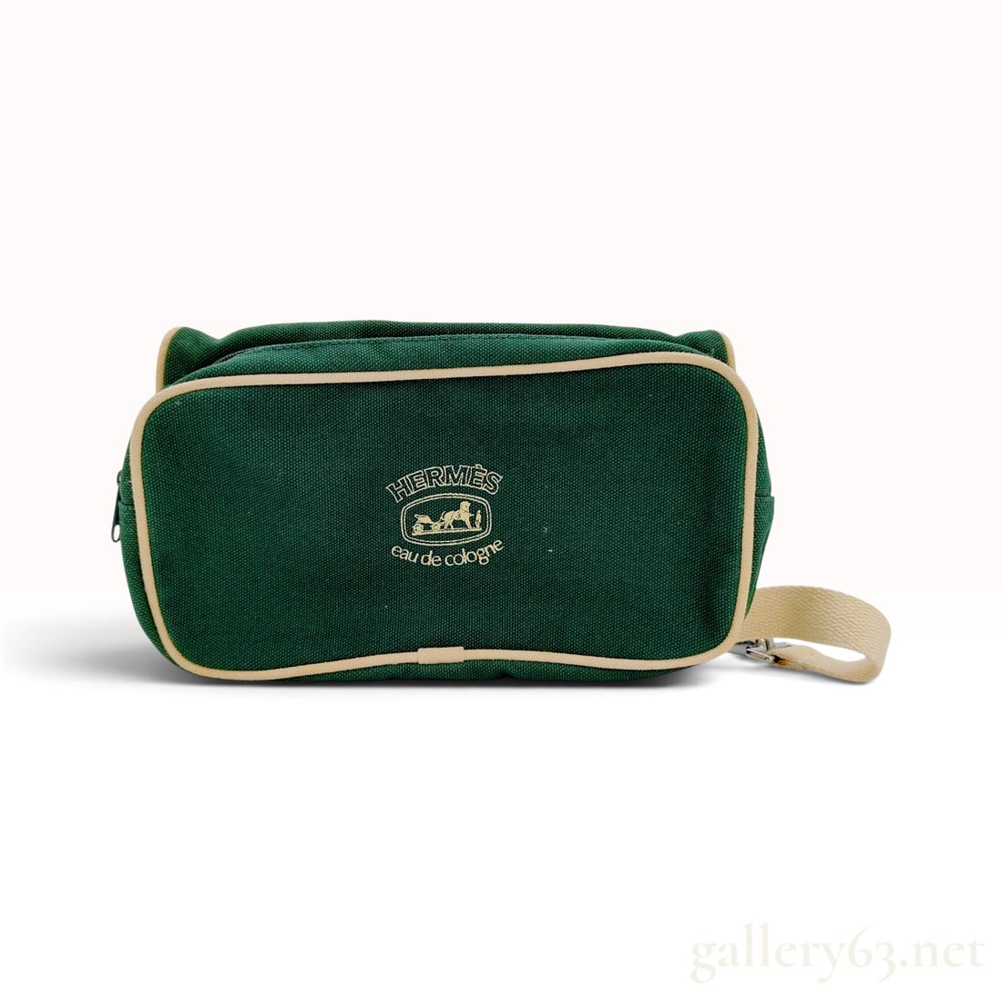 Vintage Herm?¨s Eau de Cologne Green Canvas Accessory Pouch: This Herm?¨s accessory pouch is crafted from forest green canvas with cream-colored synthetic piping and a matching woven textile strap. Designed as a promotional piece for the brand fragrance line, 