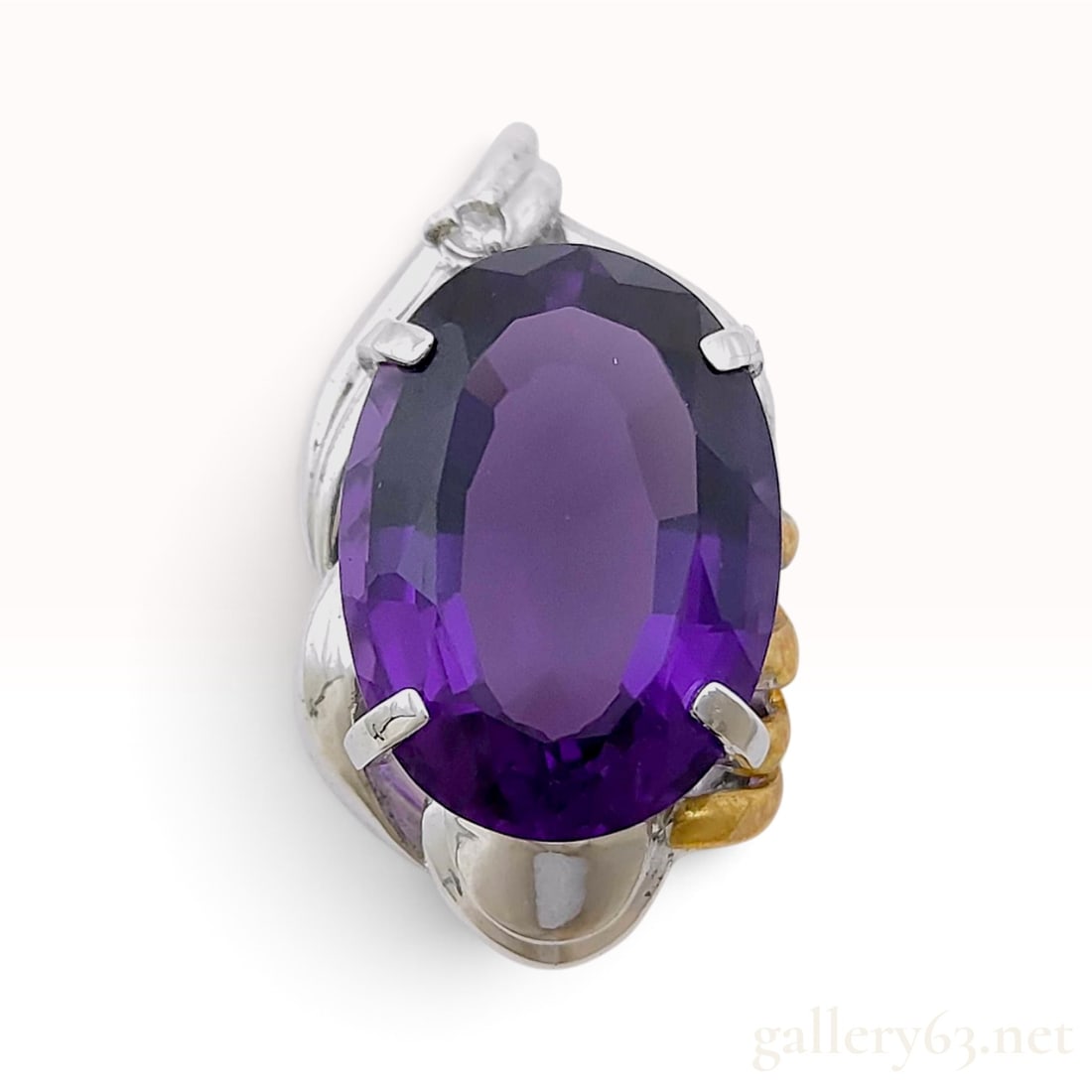 18K Yellow Gold and Sterling Silver 10.0ct Amethyst and 0.02ct Natural Diamond Pendant: A gemstone pendant crafted from sterling silver and 18 karat yellow gold featuring a large oval faceted amethyst. The central 10.0ct amethyst is secured by four silver prongs within an open-work galle