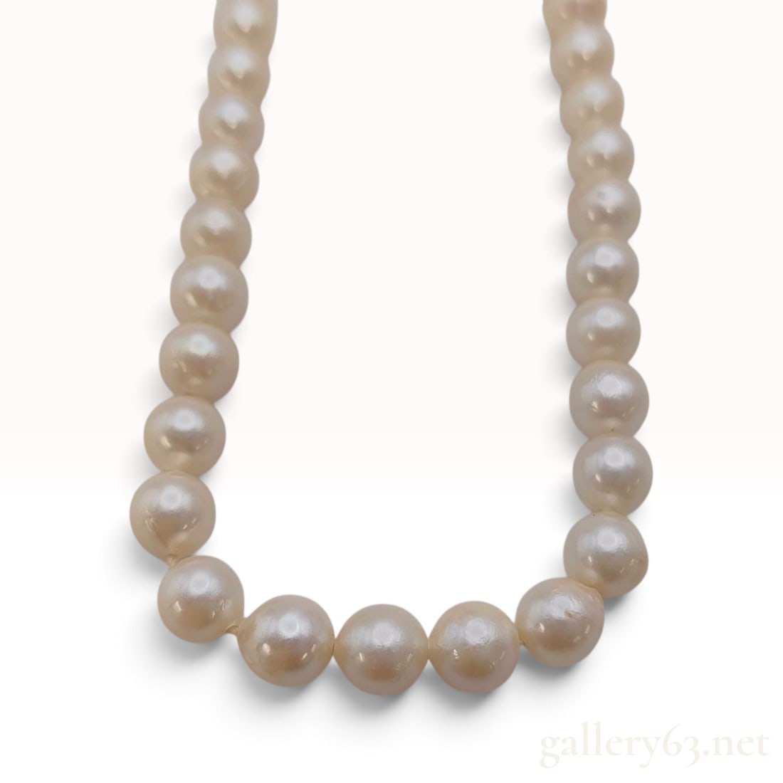Vintage Silver and 6-7mm Cultured Pearl Strand Necklace: A vintage single-strand cultured pearl necklace featuring approximately 60 pearls, each measuring between 6mm and 7mm in diameter. The pearls possess a creamy white body color and exhibit a moderate l