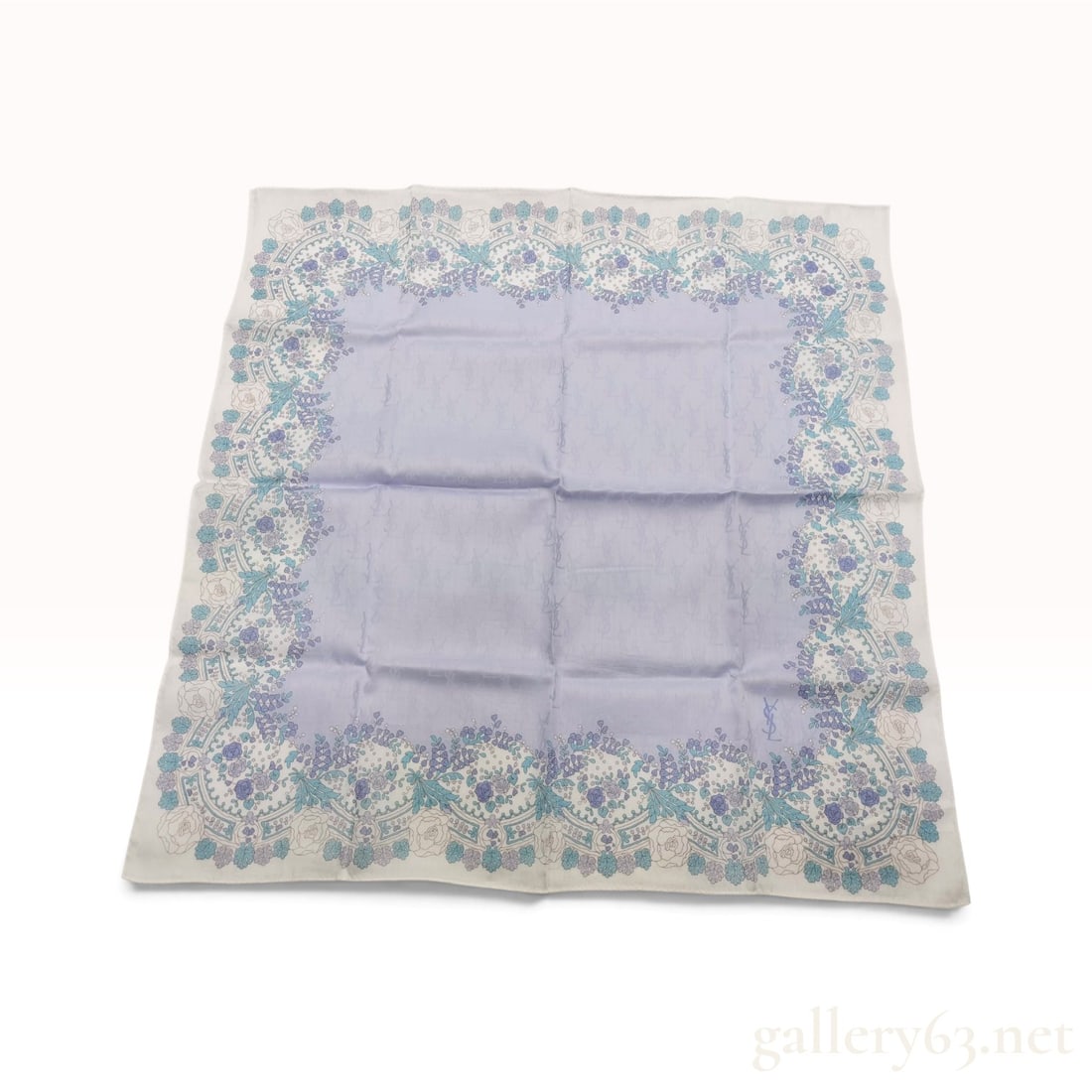 Vintage Yves Saint Laurent Floral Lace Lavender Silk Scarf 58 cm: This Yves Saint Laurent scarf is crafted from lavender silk jacquard. The central lavender field features a repeating tonal jacquard weave of the iconic superimposed YSL monogram. The border is design
