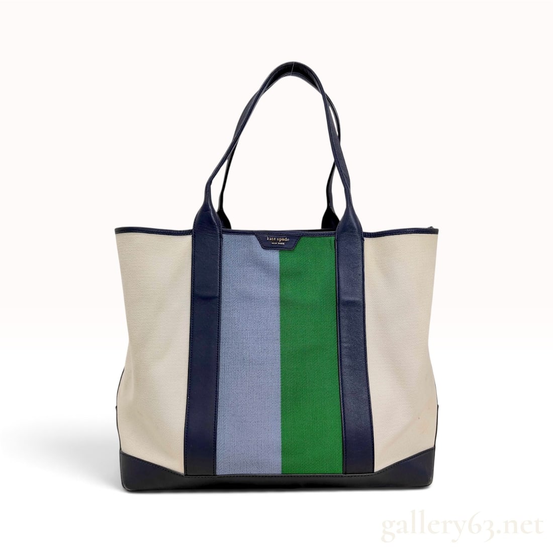 Kate Spade Striped Canvas and Navy Blue Leather Large Tote Bag with Retail Tag: This Kate Spade New York large tote bag is constructed from off-white canvas featuring two wide vertical stripes in light blue and green. The bag is trimmed with navy blue leather at the top edge, sid