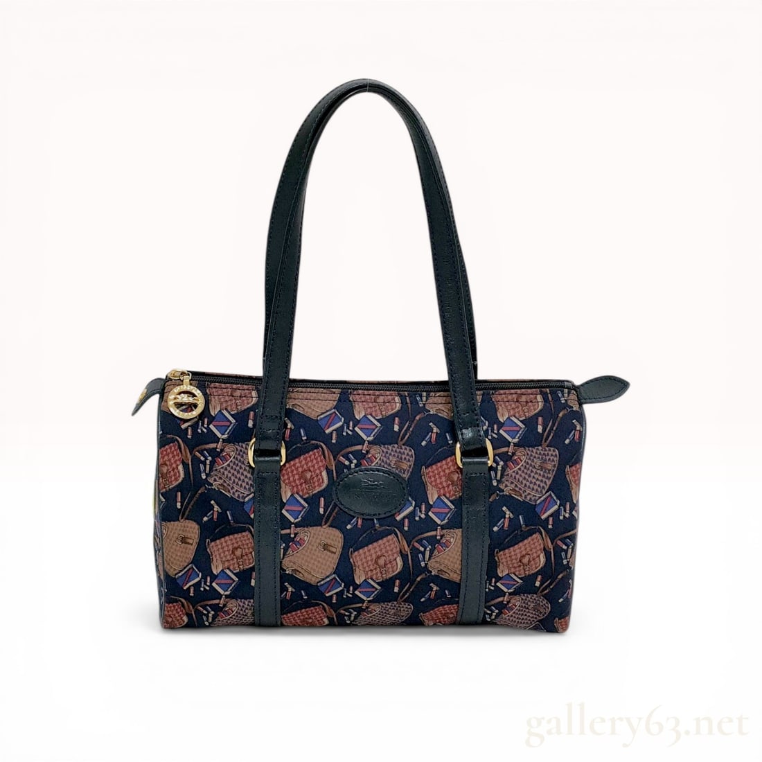 Longchamp Vintage Navy Canvas Novelty Print Shoulder Bag: Longchamp vintage small top-zip shoulder bag featuring a multi-colored novelty print of handbags and cosmetics on navy canvas. Design includes dual navy leather shoulder straps, leather trim, and a