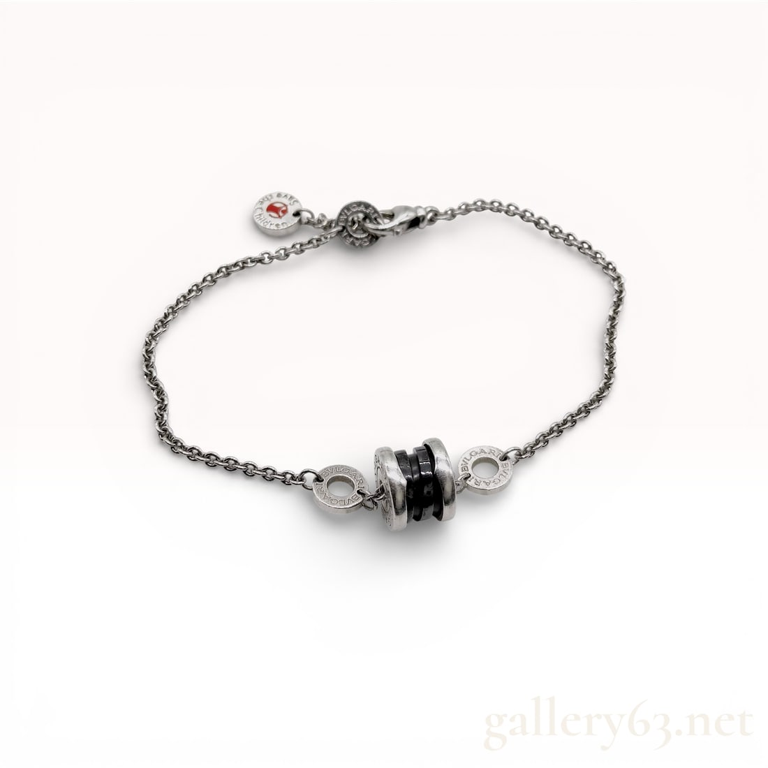 Bvlgari Save the Children Sterling Silver and Black Ceramic Bracelet: Bvlgari sterling silver and black ceramic link bracelet from the Save the Children collection. The design features a central B.zero1 style barrel bead with black ceramic rings flanked by silver rings 