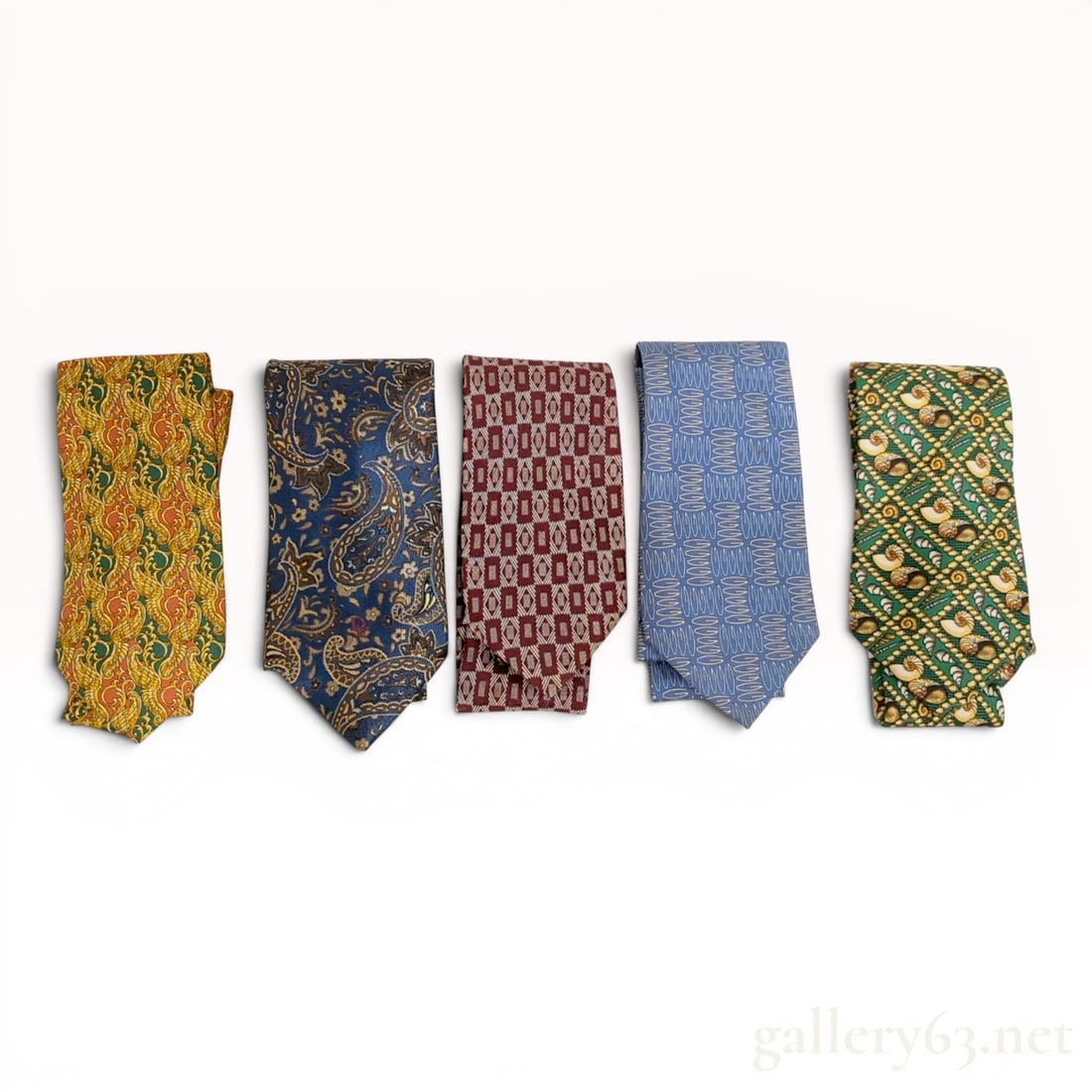 Lot of Five Designer Silk Neckties Including Christian Dior, Gucci, and Burberrys: A lot of five designer silk neckties featuring various patterns and luxury brand markings. The collection includes a Christian Dior Monsieur tie with a gold, forest green, and burnt orange acanthus