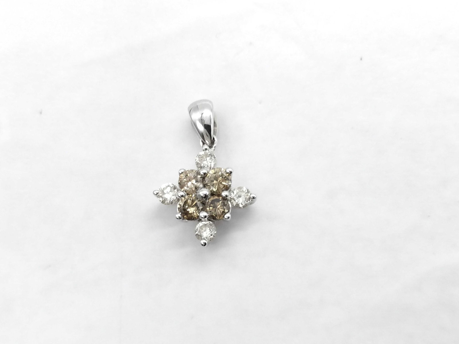 18K White Gold and 1.00ctw Diamond Cluster Pendant: This 18 karat white gold pendant features a tiered cluster arrangement of round brilliant-cut diamonds. The center of the pendant is comprised of a square grouping of four diamonds with a light brown