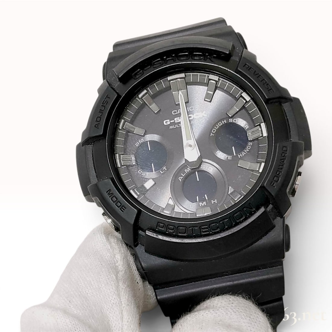 Casio G-Shock GAW-100B Module 5444 Tough Solar Multi-Band 6 Wristwatch: This Casio G-Shock GAW-100B wristwatch features module 5444 and is designed with a black resin case and a stainless steel case back. The dark grey sunburst dial incorporates three digital sub-dials, s