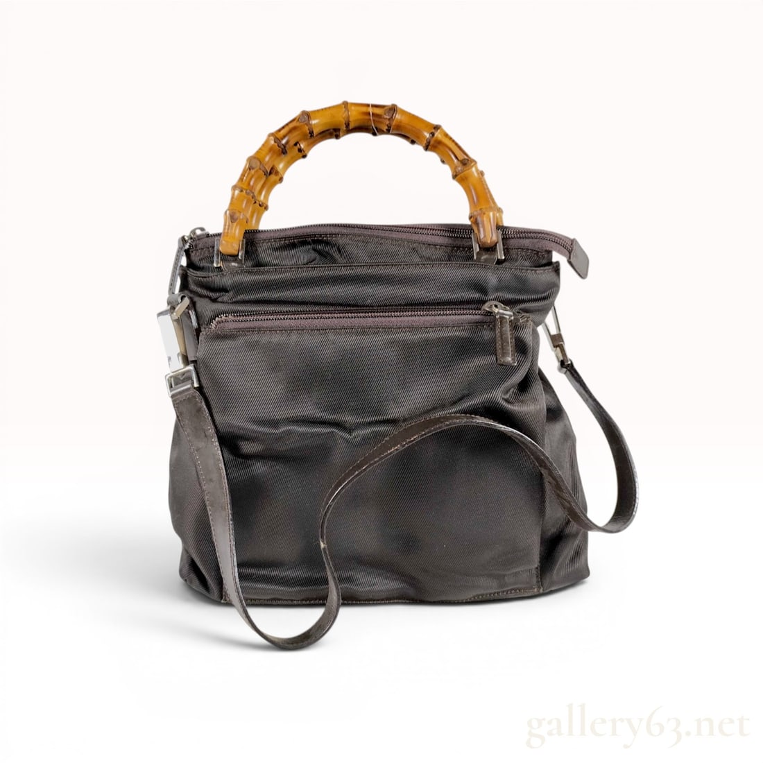 Gucci Vintage Dark Brown Nylon Bamboo Handle Multi-Zip Handbag: Vintage Gucci multi-compartment handbag featuring signature curved bamboo top handles and a dark brown technical nylon canvas body. The exterior design includes three tiered horizontal zippered pocket