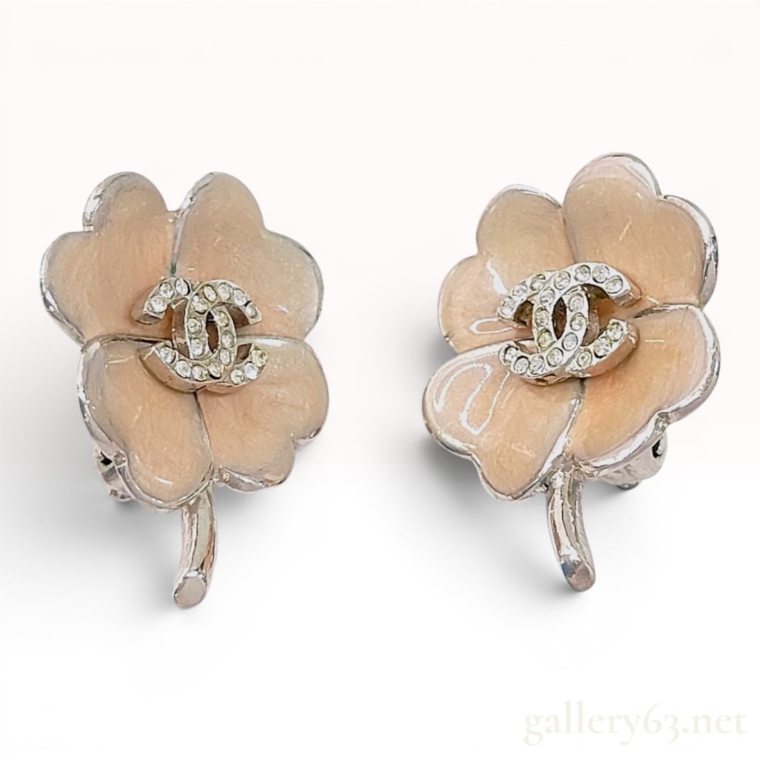 A Pair of Chanel Enamel and Crystal CC Clover Clip-On Earrings: A pair of Chanel costume clip-on earrings in the form of four-leaf clovers, identified by hallmarks as part of the Spring 2004 collection. The earrings are fashioned from silver-tone metal with peach-