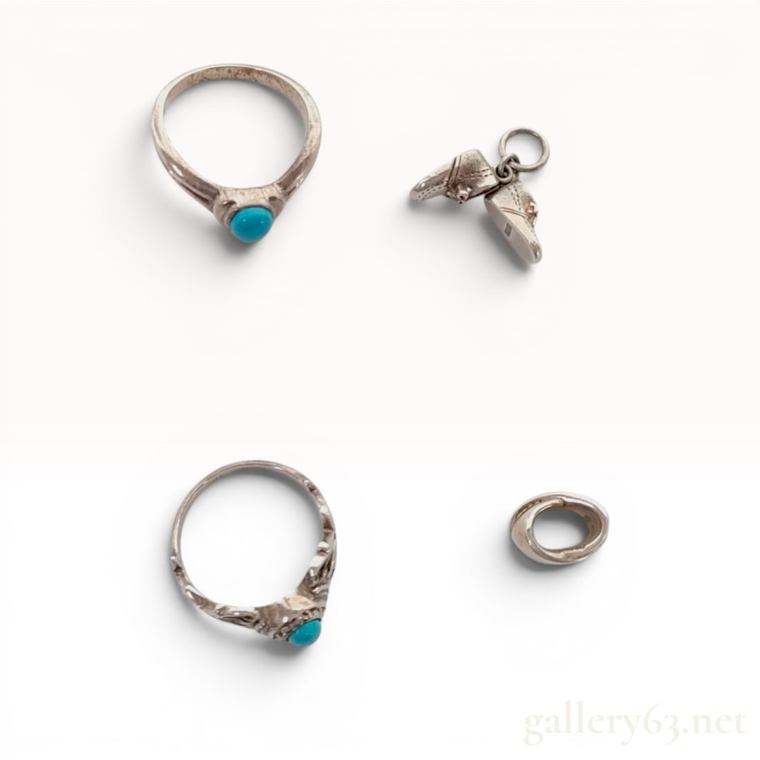An Assortment of Four Silver and Turquoise Jewelry Items: An assortment of four silver jewelry items including two turquoise cabochon rings, a wrap-style band, and a miniature shoe charm. The rings feature bezel settings, with one displaying an ornate foliat