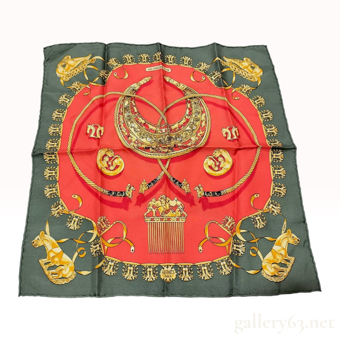 Hermes Les Cavaliers d'Or Silk Gavroche Pocket Square: Hermes silk gavroche pocket square in the Les Cavaliers d'Or pattern designed by Vladimir Rybaltchenko. Silk twill construction with hand-rolled edges featuring ancient Scythian-style gold jewelry mot
