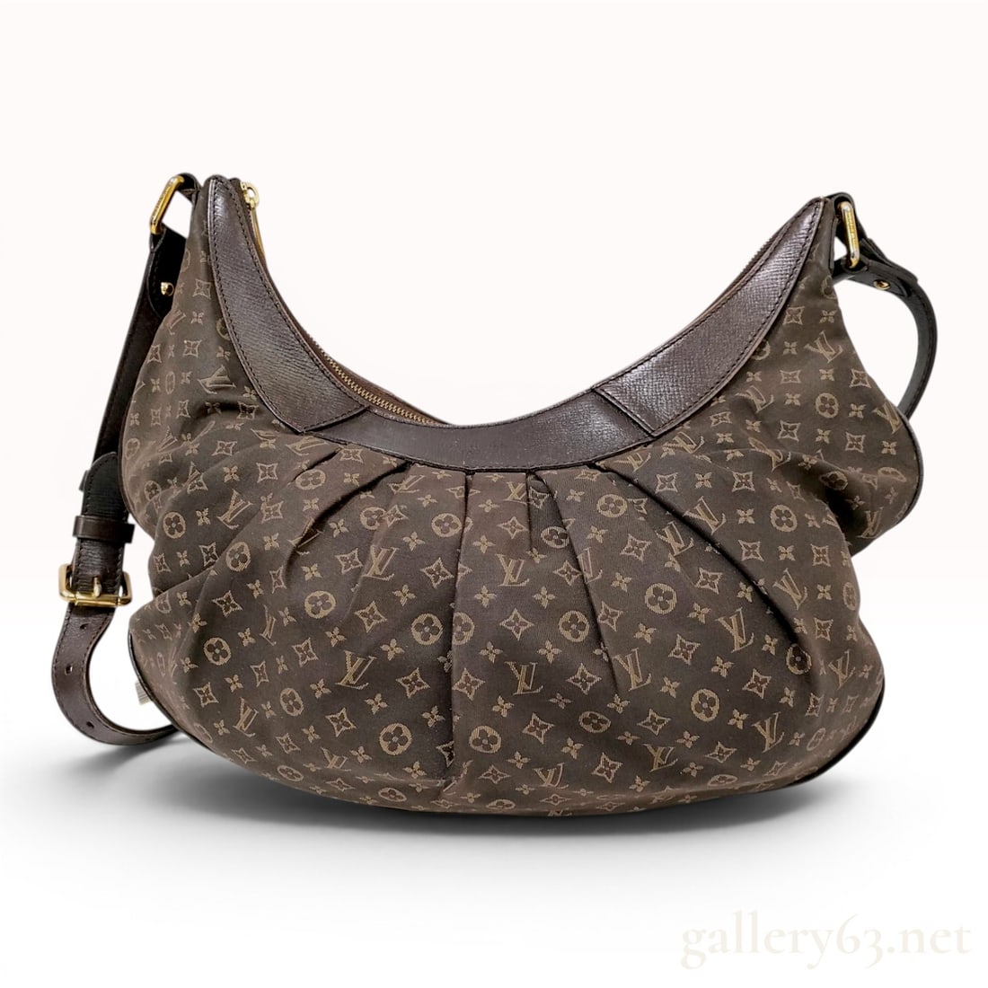 Louis Vuitton Monogram Mini Lin Rhapsody MM Shoulder Bag: This Louis Vuitton Rhapsody MM shoulder bag is constructed from Ebene Monogram Mini Lin canvas, which is a textile blend of cotton, linen, and silk. The bag features a crescent hobo silhouette with a 