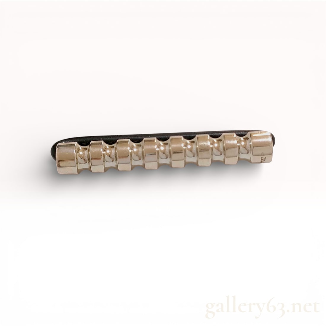 Sterling Silver and Rubber Cord Bracelet, Paloma Picasso for Tiffany and Co. Groove Roller: This contemporary minimalist bracelet, designed by Paloma Picasso for Tiffany and Co., features a central sterling silver bar with a distinctive notched Groove Roller design. The sculptural silver ele