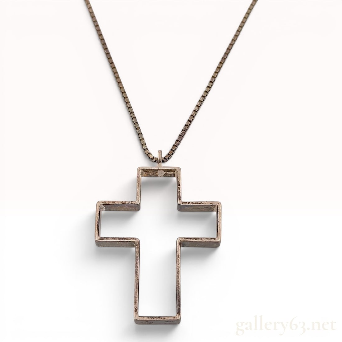 Gucci Sterling Silver Large Hollow Cross Pendant Necklace: This is a Gucci designer pendant necklace crafted from sterling silver. The piece features a large, hollow, open-form rectangular cross pendant suspended from a thin box chain. The necklace is secured