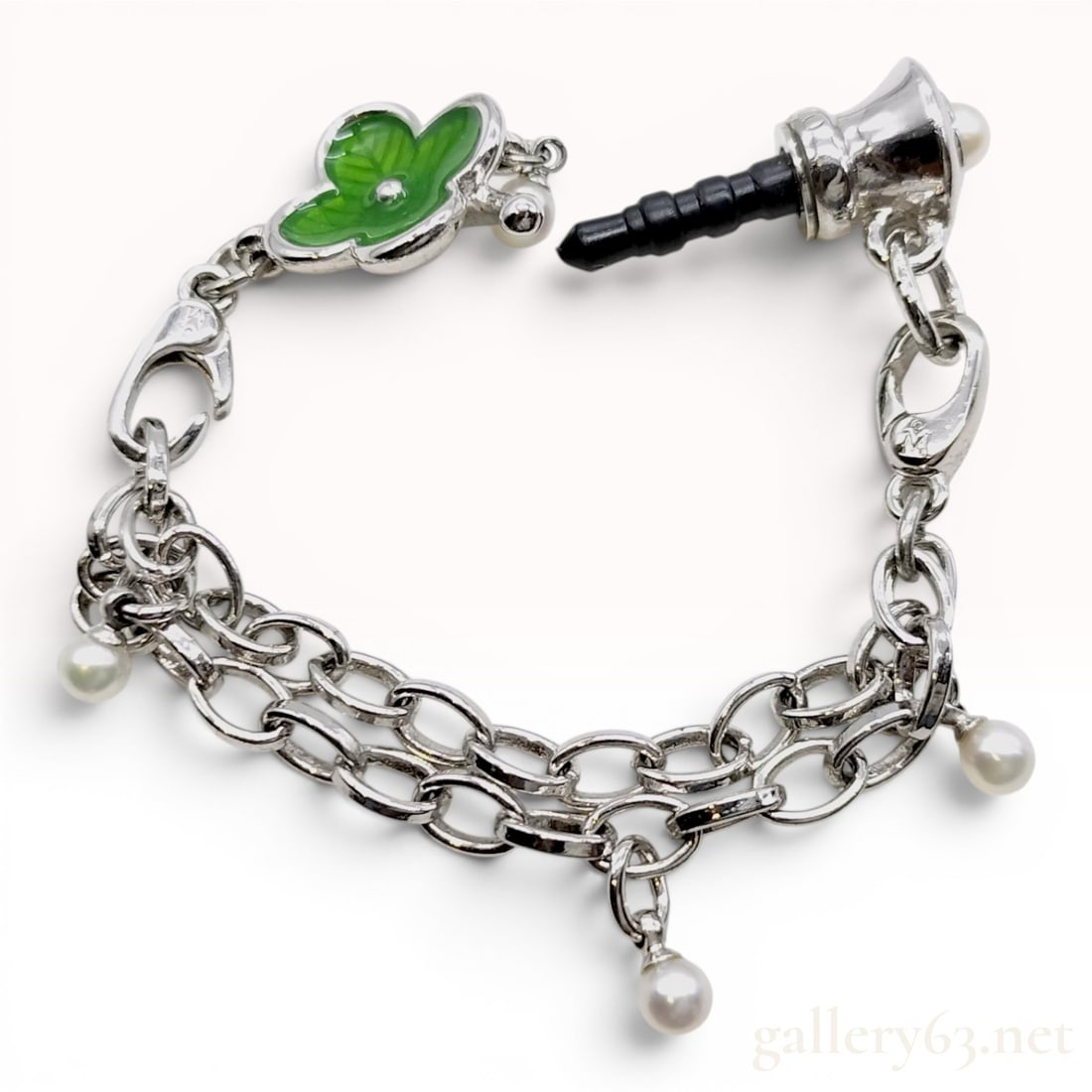 Mikimoto Pearl and Enamel Four-Leaf Clover Mobile Phone Jack Charm: This is a contemporary mobile phone accessory manufactured by Mikimoto, designed as a 3.5mm headphone jack dust plug. The piece features a double-row silver-toned chain adorned with five small culture