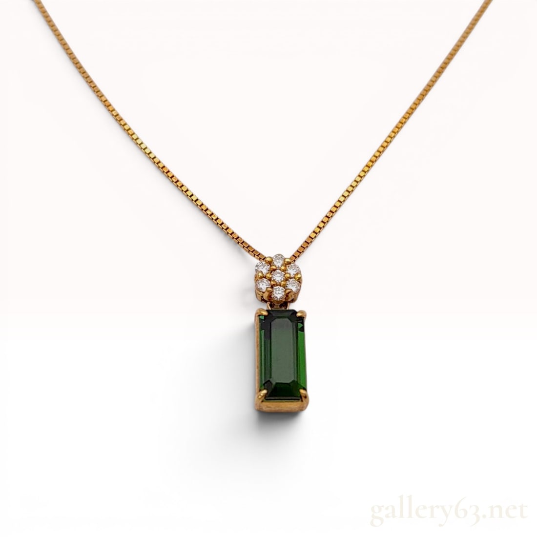18 Karat Yellow Gold Green Tourmaline and Diamond Pendant Necklace: This necklace is crafted from 18 karat yellow gold and features a pendant set with a rectangular step-cut green tourmaline and a floral cluster of round brilliant-cut diamonds. The primary green tourm