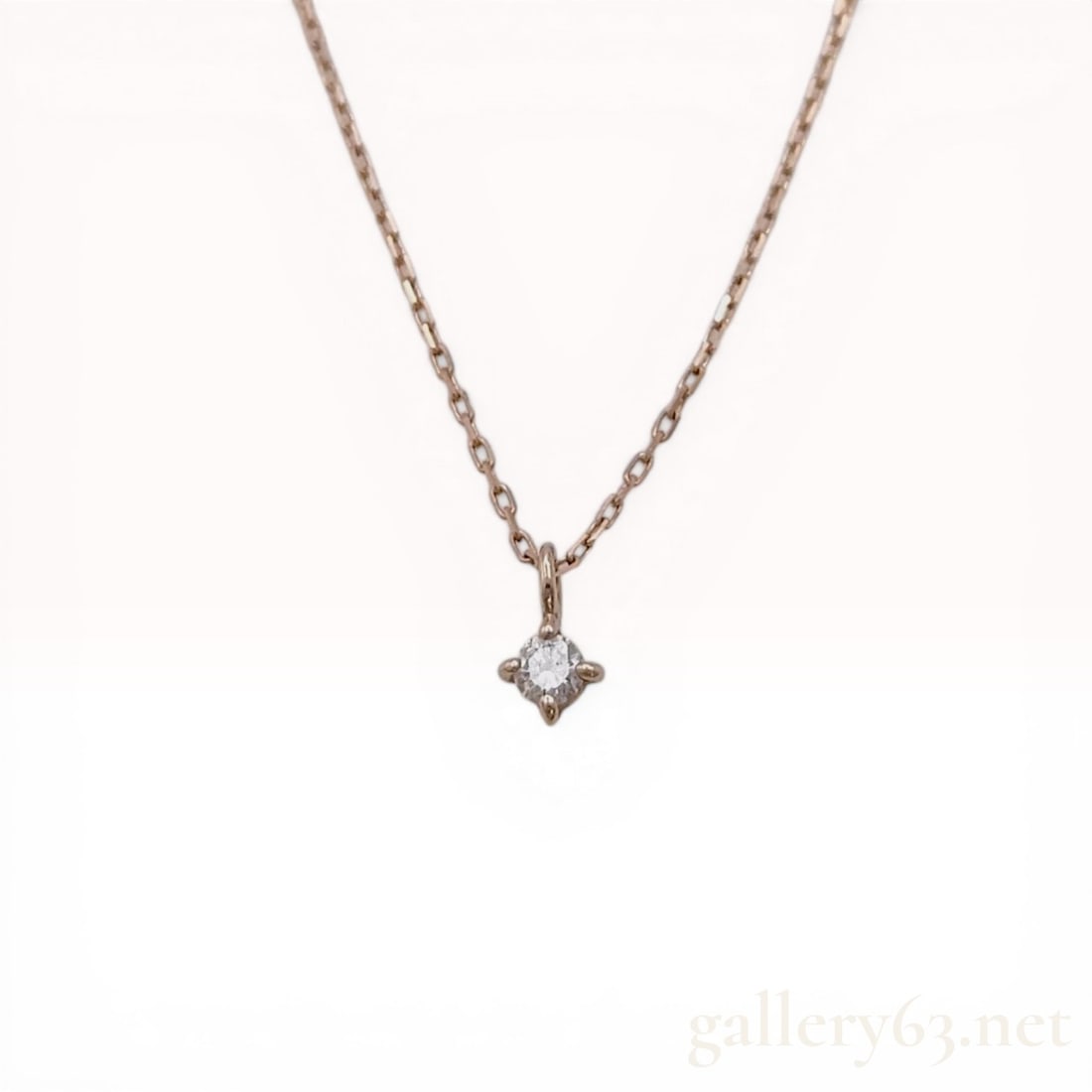 Ete 10 Karat Rose Gold and Diamond Solitaire Pendant Necklace: Japanese Ete 10 karat rose gold and diamond solitaire pendant necklace, contemporary. The minimalist design features a round-cut diamond in a four-prong setting suspended from a fine cable link