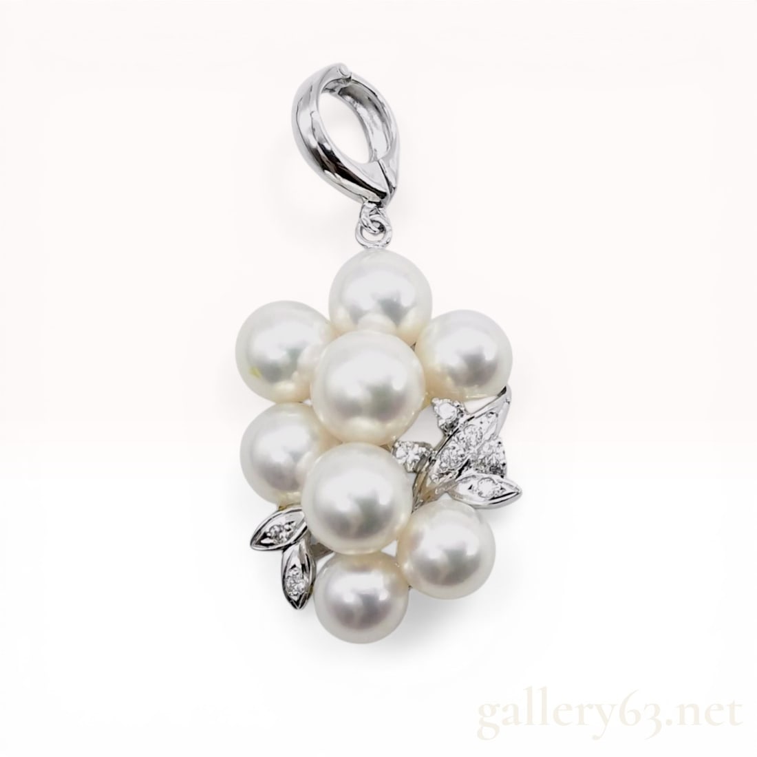 Cultured Pearl and Diamond Grape Motif Cluster Pendant Enhancer in 14 Karat White Gold: Grape motif cultured pearl and diamond cluster pendant enhancer, late 20th century. The piece features nine round white cultured pearls accented by small round brilliant-cut diamonds set in stylized w